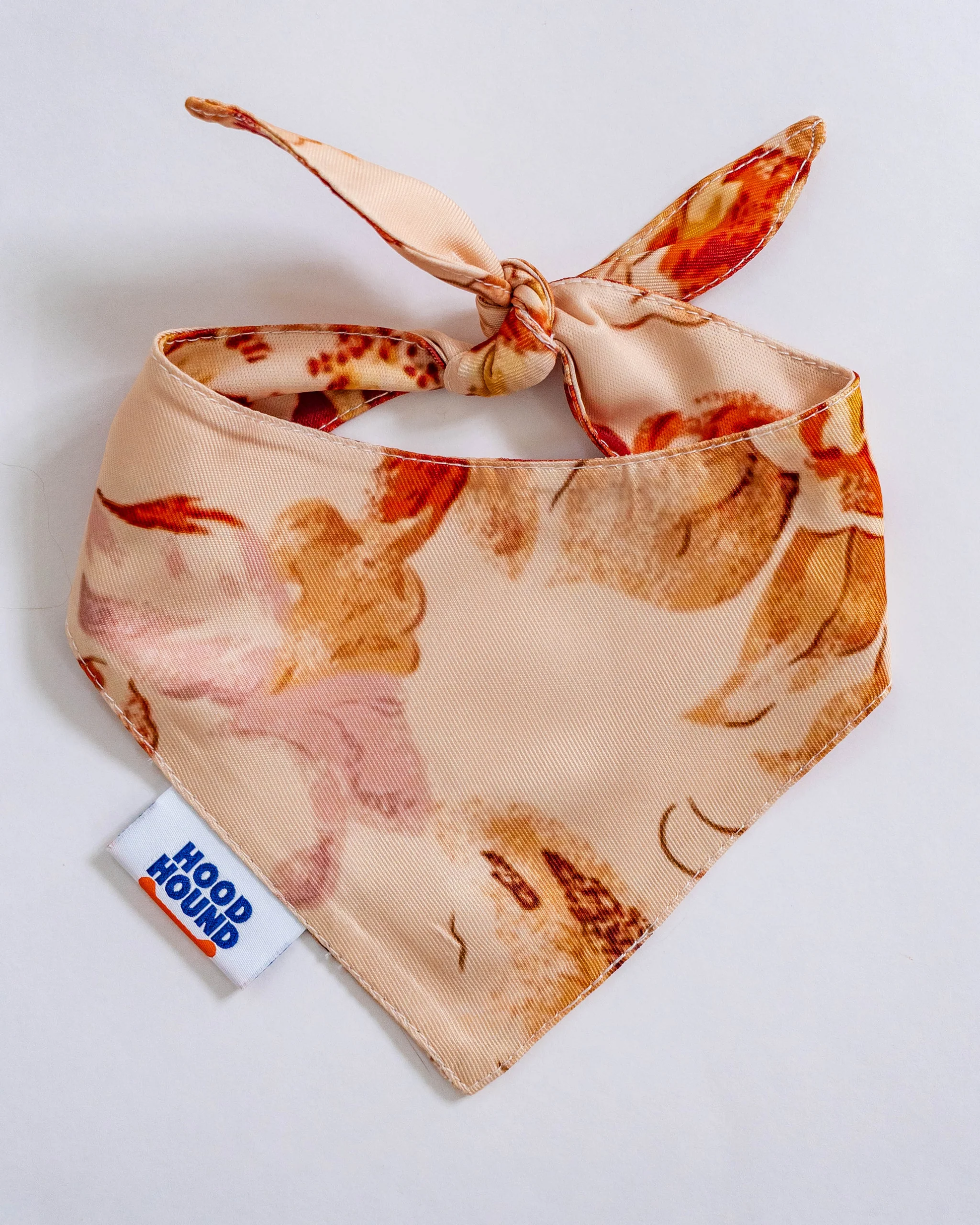 Floral patterned bandana with a visible brand tag on a light background