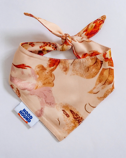 Floral patterned bandana with a visible brand tag on a light background